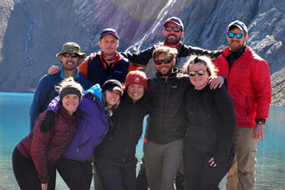 Students on an expedition to Patagonia posing in front of mountains and a lake