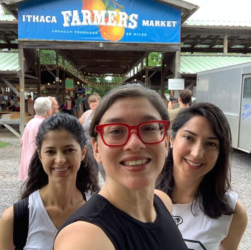 Three students take a selfie at the Ithaca Farmer's Market