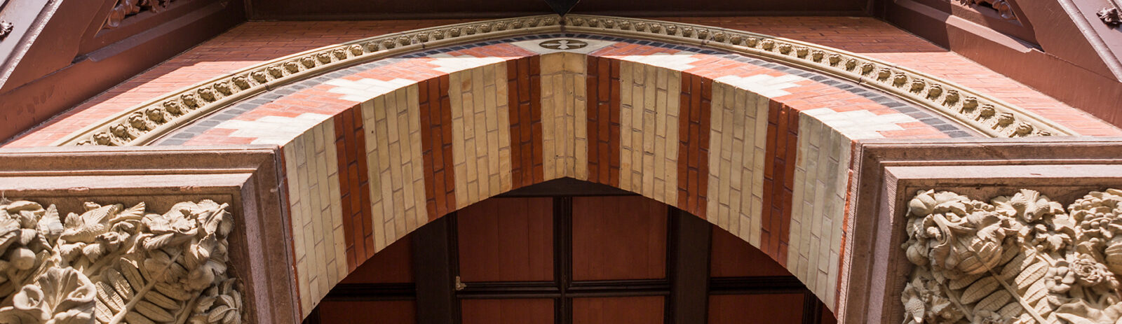 Sage Hall stonework archway above a doorway.