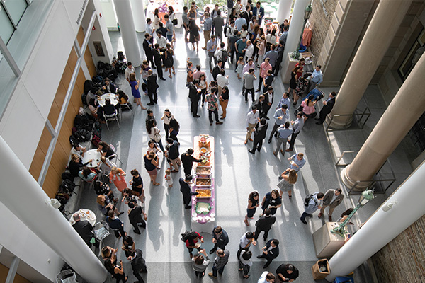 Aerial view of people milling about around a buffet table.