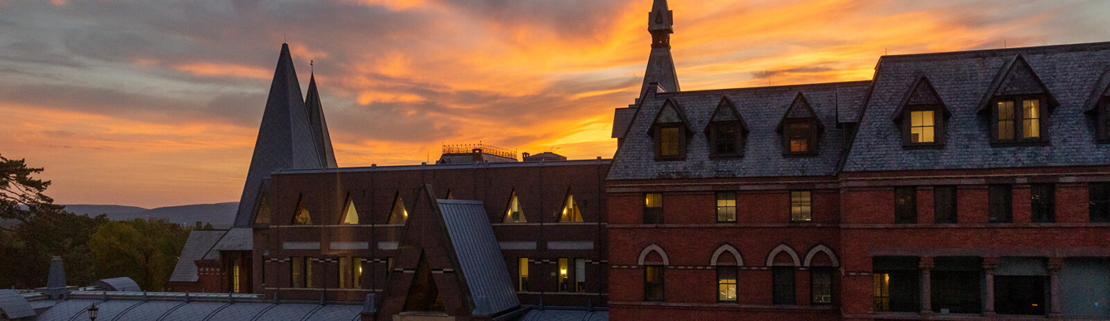 Sage Hall with a vibrant sunset behind the building.