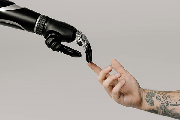 Illustration of a computer generated hand touching a human hand.